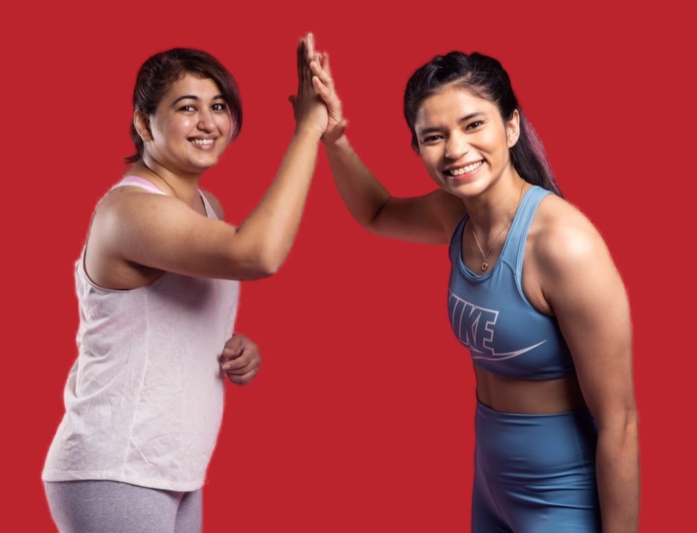 Two BoxFit members high-fiving after a workout